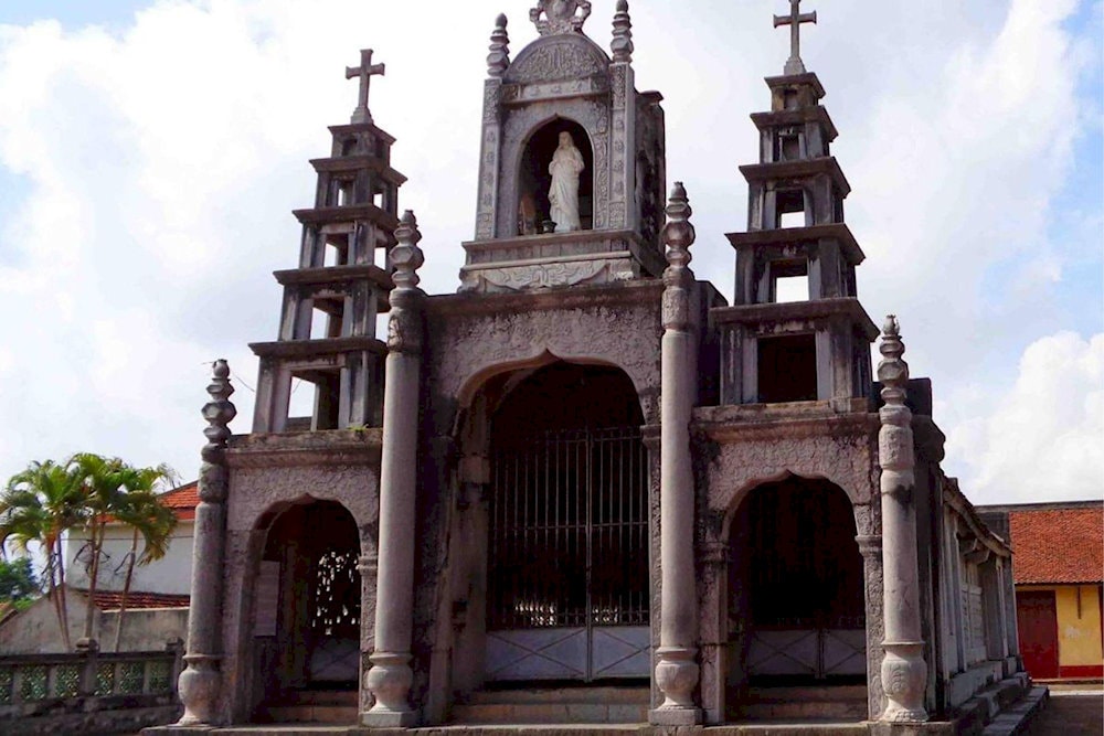 The Church of the Sacred Heart of Mary, made entirely of stone, features a gilded sanctuary with intricate carvings, creating a peaceful atmosphere